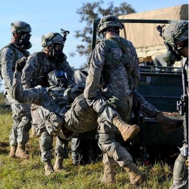 Soldiers carrying wounded man