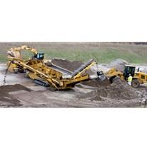 Big yellow construction machine digging into the soil