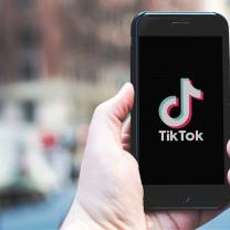 TikTok on iPhone in hand.  Photo is released under Creative Commons. Please use freely with attribution in the form of a link to nordskovmedia.dk as the image owner.
