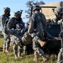 Soldiers carrying wounded man